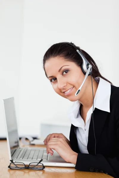 A smiling young operator in her office — Stock Photo, Image