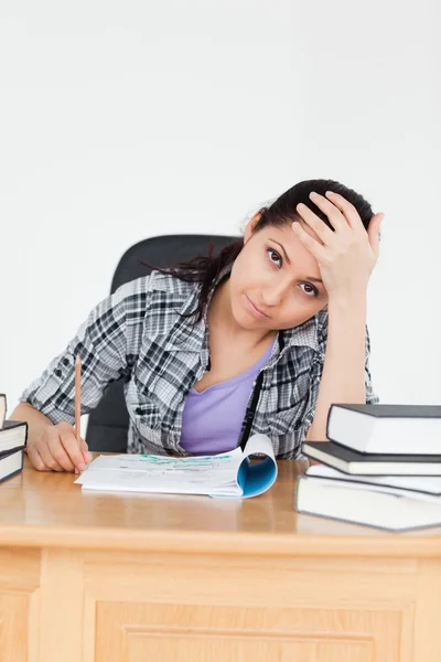 Tired young student with homework — Stock Photo, Image
