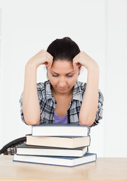 Joven estudiante frustrado descansando en libros — Foto de Stock