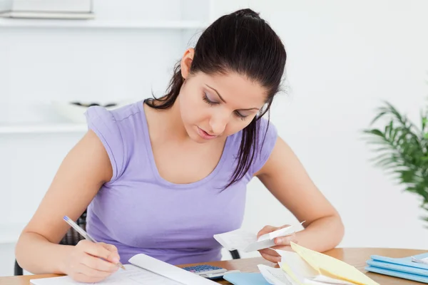 Bored young woman accounting — Stock Photo, Image