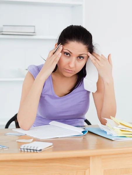 Tired young female doing banking — Stock Photo, Image