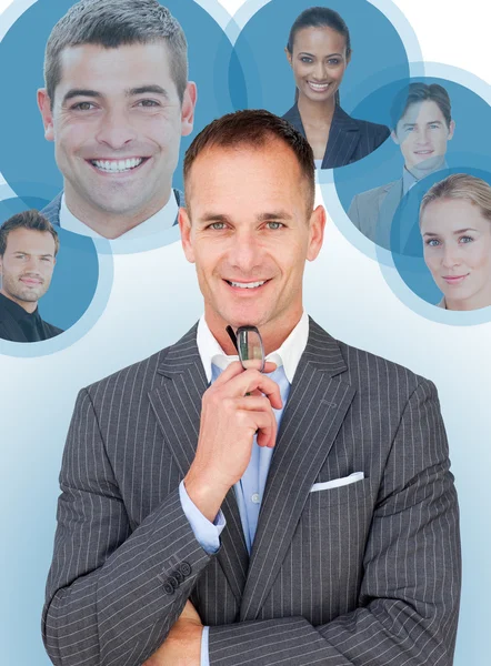 Businessman and pictures of his colleagues — Stock Photo, Image