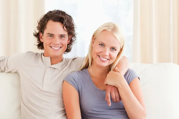 Couple sitting on a sofa Stock Picture