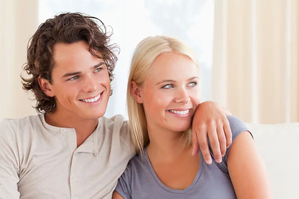 Cute couple sitting on a couch Stock Image