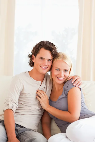 Portrait of a lovely couple sitting on a couch Stock Photo