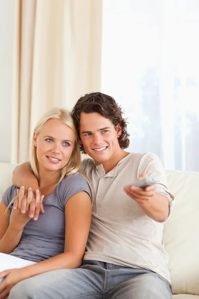 Portrait of a couple watching TV Stock Picture