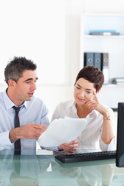 Manager pointing at something to his secretary on a blueprint do — Stock Photo, Image