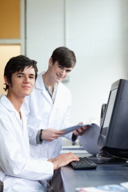 Portrait of male scientists with a monitor clipart