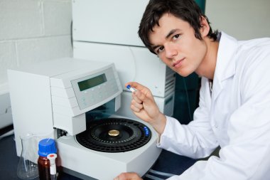 Student posing with a centrifuge clipart