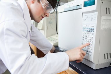 Science student using a laboratory chamber furnace in a laborato clipart