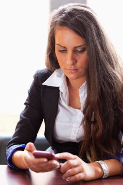 Young woman dialing on her smartphone clipart