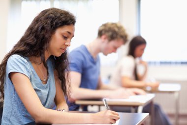 Studious young adults working on an essay clipart