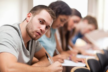 Students sitting for an examination clipart