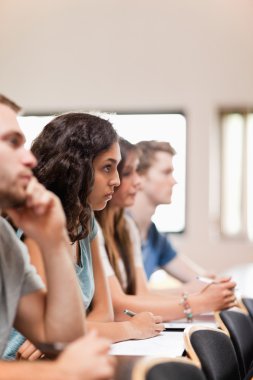 Portrait of students listening a lecturer clipart