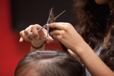 Close up of a hand cutting hair clipart