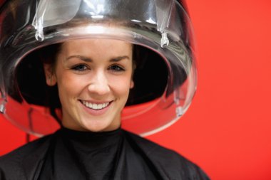 Student under a hairdressing machine clipart