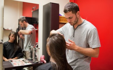 Male hairdresser cutting hair clipart