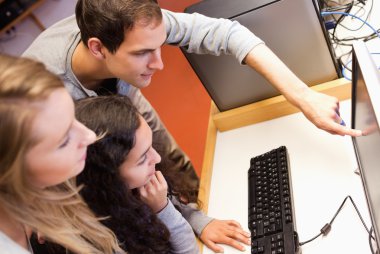 Fellow students using a computer clipart