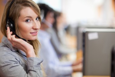 Close up of a blonde operator posing with a headset clipart