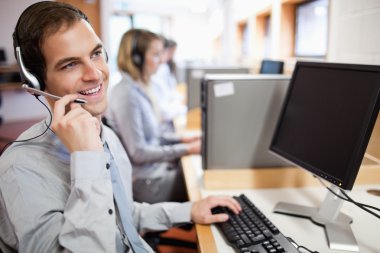 Smiling assistant using a headset clipart