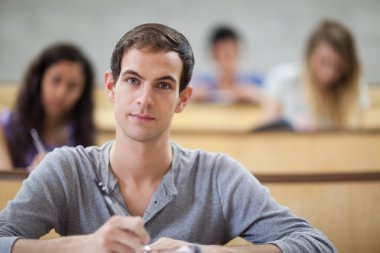 College students taking notes in an amphitheater clipart