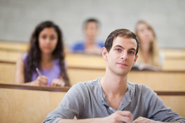 Young students listening during a lecture clipart