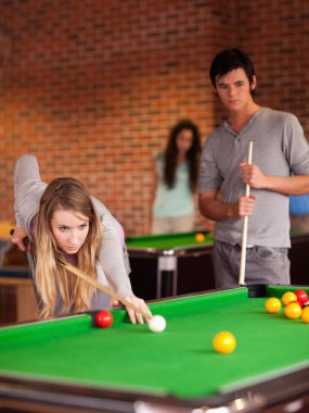 Portrait of friends playing snooker clipart