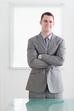 Business man with his arms folded and smiling clipart