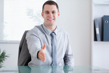 Smiling businessman greeting his negotiation partner clipart