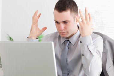 Close up of businessman experiencing problems with his laptop clipart