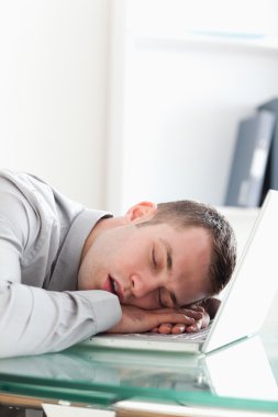 Overworked businessman taking a nap clipart