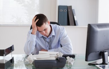 Businessman frustrated by paperwork clipart