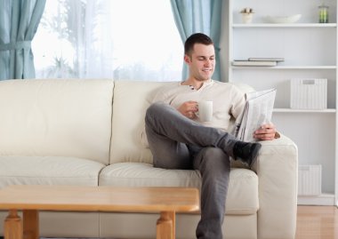 Man having a coffee while reading the news clipart