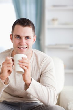 Portrait of a man having a coffee clipart