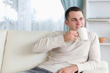 Attractive man having a tea clipart