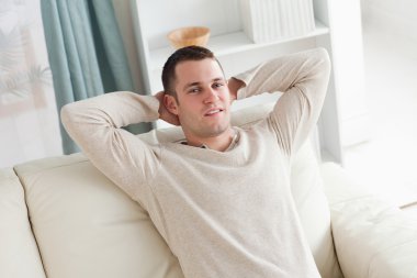 Man relaxing on a couch clipart