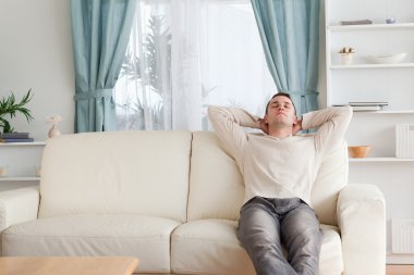 Man resting on a couch clipart