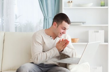 Happy man using a notebook clipart