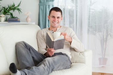 Happy man reading a book clipart