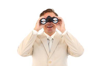 Smiling businessman looking through binoculars clipart