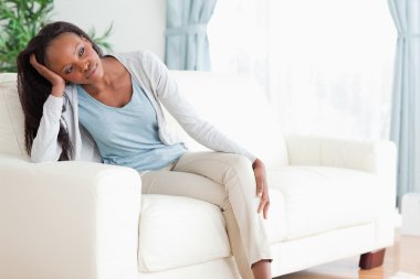 Woman on sofa in thoughts clipart