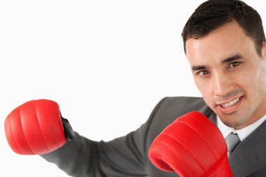 Side view of businessman with boxing gloves clipart