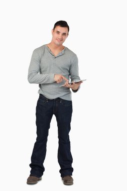 Young male working on tablet clipart