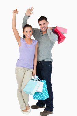 Happy young couple after shopping clipart