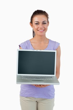 Smiling young female showing her laptop clipart