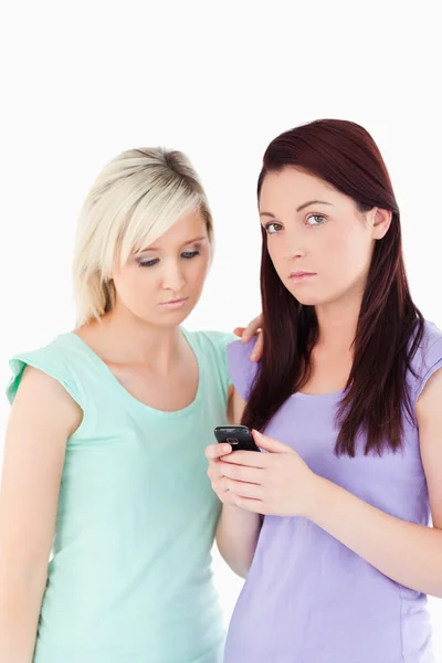 Portrait of sad women with a cellphone — Stock Photo, Image