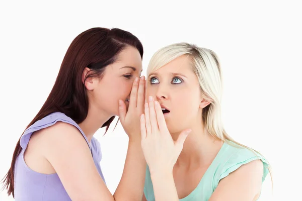 Portrait of a young woman telling her friend a secret — Stock Photo, Image