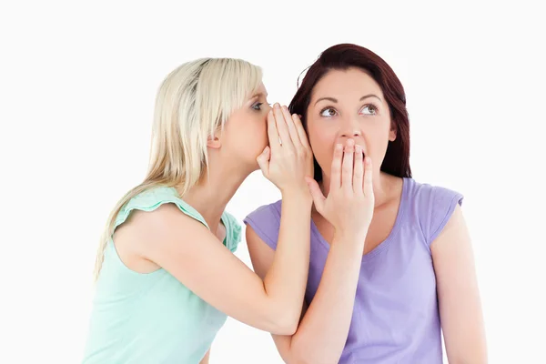 Portrait of a gorgeous woman telling her friend a secret — Stock Photo, Image