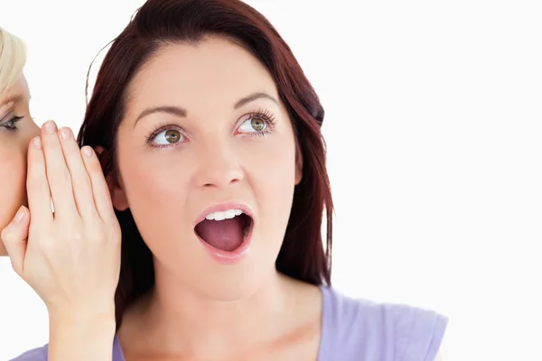 Close up of a surprised women being told a secret — Stock Photo, Image
