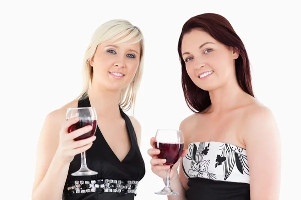 Charmiga välklädda kvinnor dricker rött vin — Stockfoto